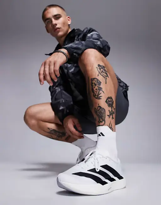 Nike Running Vomero 18 sneakers in white and blue